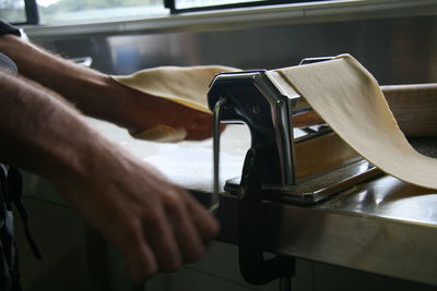 Close-up of person holding hands on table