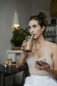 Midsection of a woman drinking glass