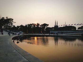 Scenic view of river against sky at sunset