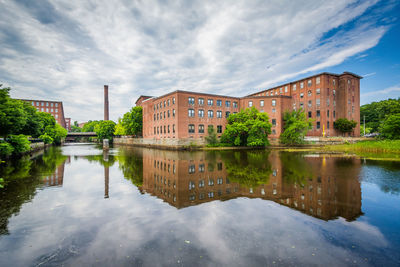 Reflection of buildings in lake against sky