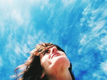 Smiling woman against sky
