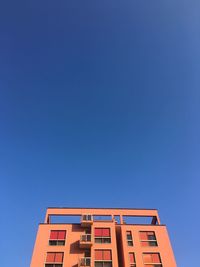 Low angle view of building against clear blue sky