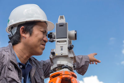 Close-up of surveyor working outdoors
