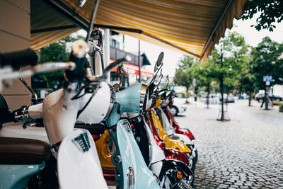 Close-up of motor scooters in a row on street