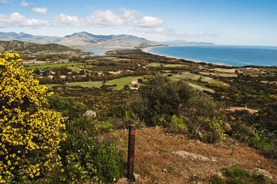 Scenic view of sea and mountains against sky