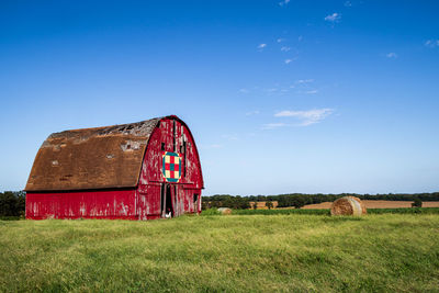 Hay bales on field against sky