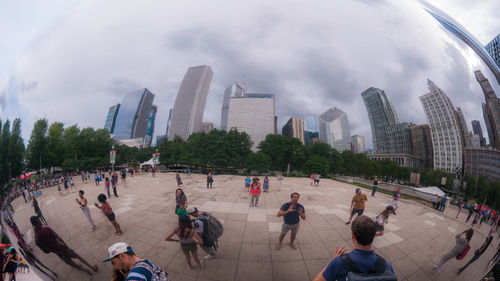 Group of people in city against buildings