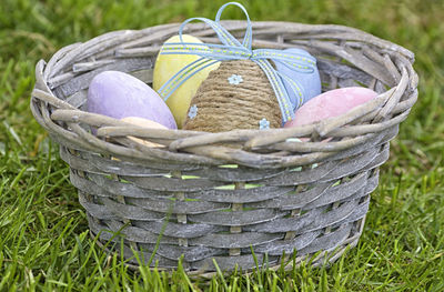 Close-up of easter eggs in basket on field