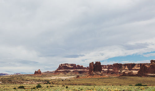 View of rock formations on landscape against sky