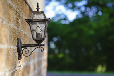 Close-up of lantern hanging on wall