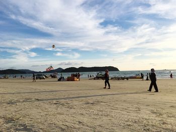 People on beach against sky