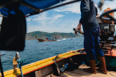 Rear view of man walking on boat