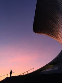 Low angle view of silhouette man against clear sky