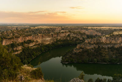 Scenic view of lake against sky during sunset