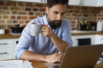 Businessman man holding coffee cup working at office