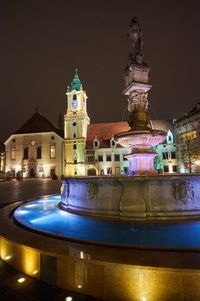 Illuminated building against sky at night