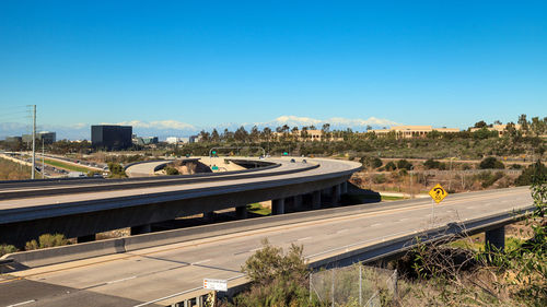 High angle view of railroad tracks against clear blue sky