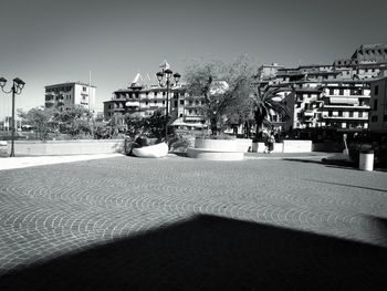 Street amidst buildings against clear sky