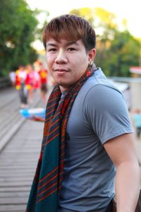 Portrait of young man with face paint wearing shawl on street