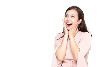 Portrait of a young woman against white background