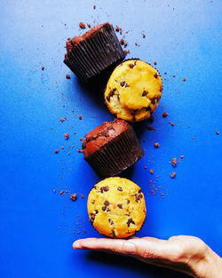 Close-up of hand holding cakes 