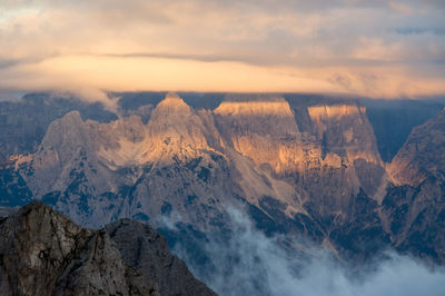 Scenic view of snowcapped mountains against sky during sunset