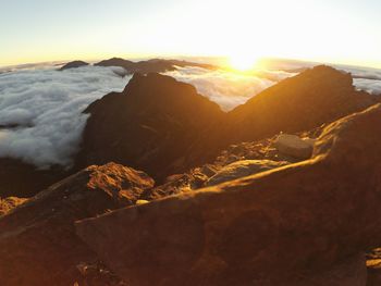 Scenic view of sea and mountains against sky during sunset