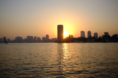 City at waterfront during sunset