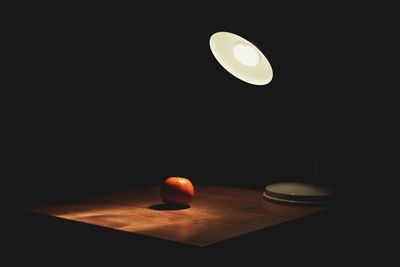 Close-up of illuminated lamp on table