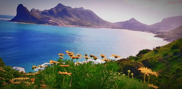 Scenic view of sea and mountains against sky