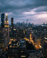 High angle view of illuminated cityscape against sky at dusk