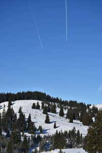 Scenic view of snowcapped mountains against clear blue sky