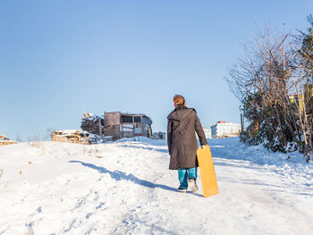 Full length of man on snow field against clear sky