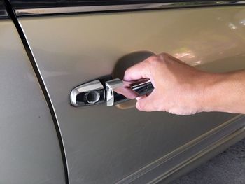 High angle view of hands holding car