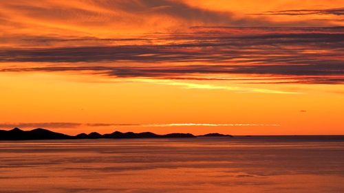 Scenic view of sea against orange sky