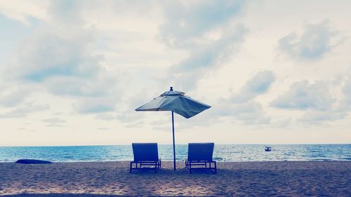 Lifeguard hut on beach against sky