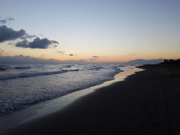 Scenic view of beach against sky during sunset