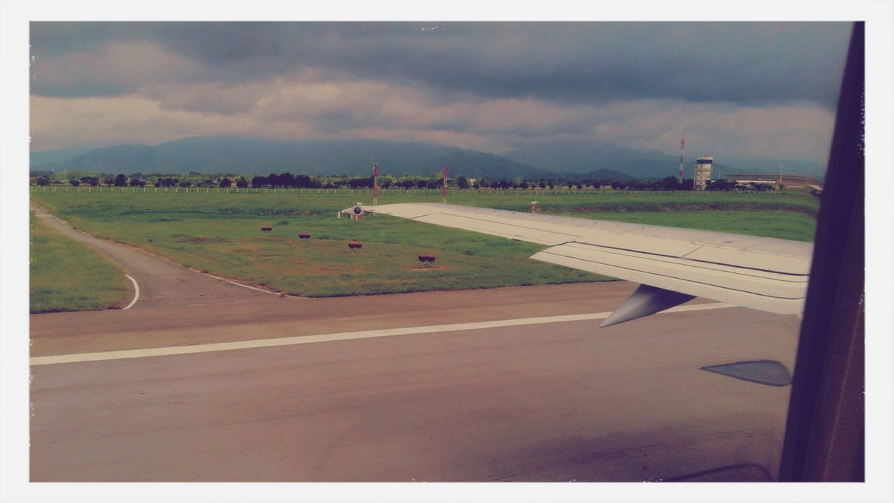 transfer print, sky, transportation, auto post production filter, cloud - sky, road, landscape, road marking, cloudy, the way forward, cloud, airplane, empty, field, built structure, mode of transport, nature, day, high angle view, no people