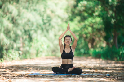 Portrait of young woman in practicing yoga in at park