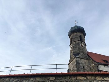 Low angle view of tower against cloudy sky