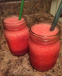 Close-up of red drink on sand