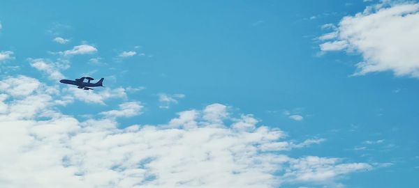 Low angle view of airplane flying in sky