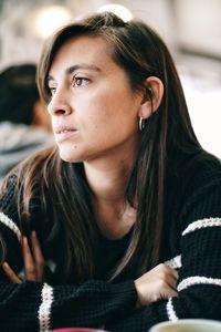Close-up portrait of a young woman looking away