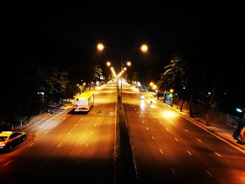 Cars on city street at night