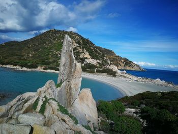 Scenic view of rocky beach against sky