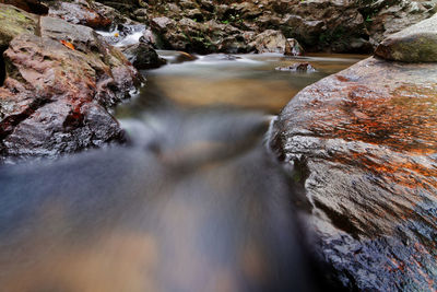 Scenic view of stream flowing through rocks