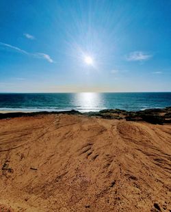 Scenic view of beach against blue sky