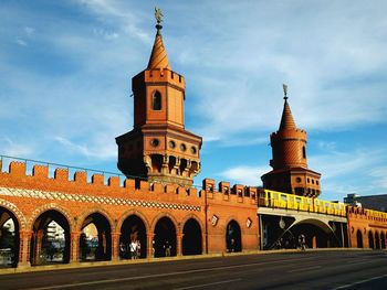 Historic oberbaum bridge with passing train against sky