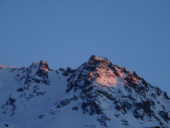 Scenic view of snowcapped mountains against clear sky