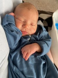 High angle view of baby boy sleeping on bed at home